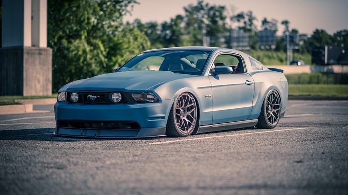 Blue Ford Mustang GT 5.0 parked on asphalt