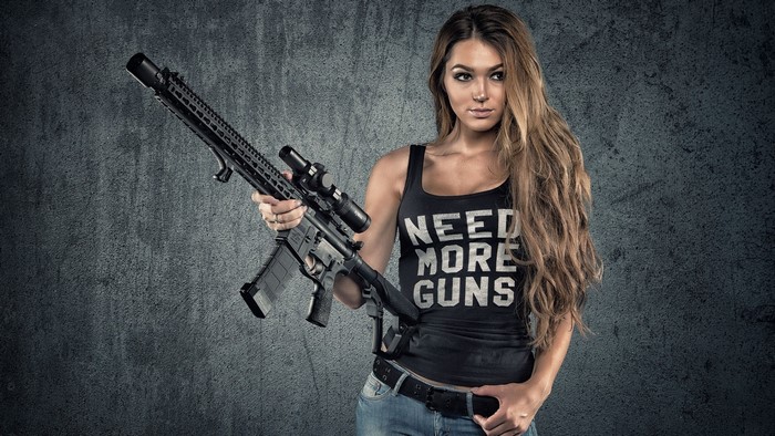 Woman holding an AR-15 rifle