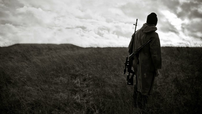 Man with rifle in field