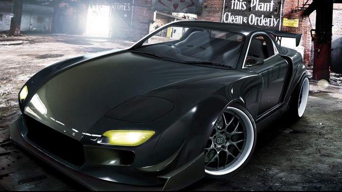 Black modified sports car in an industrial setting