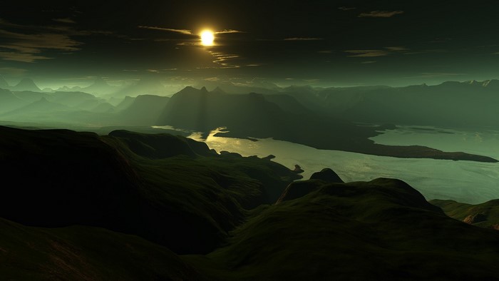 Mountainous landscape with a lake at sunset