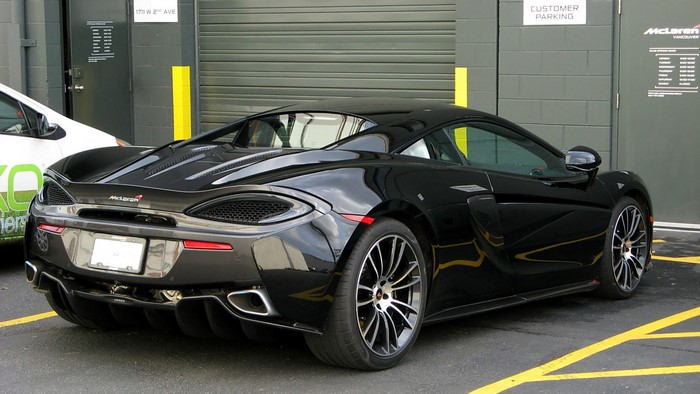 Black McLaren 570S parked outside building