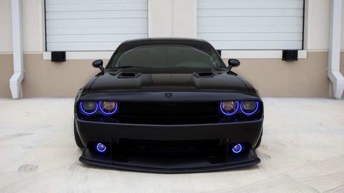 Black Dodge Challenger with blue halo headlights