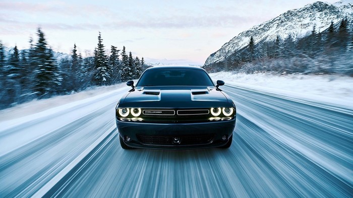 Dodge Challenger GT AWD driving on a snowy road