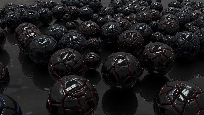 Many black textured balls on a reflective surface