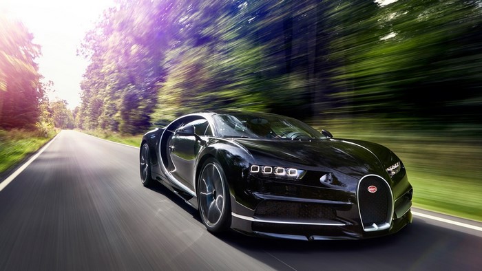 Black Bugatti Chiron driving on a road