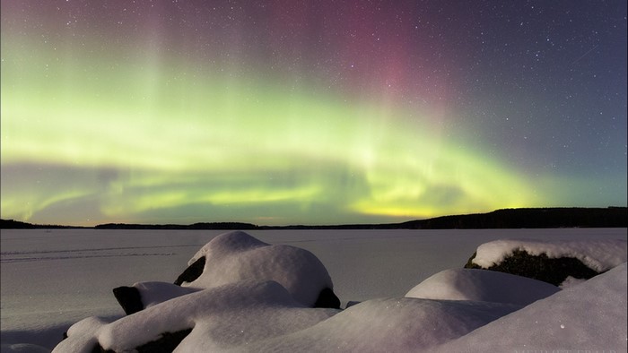 Aurora Borealis over a Snowy Landscape
