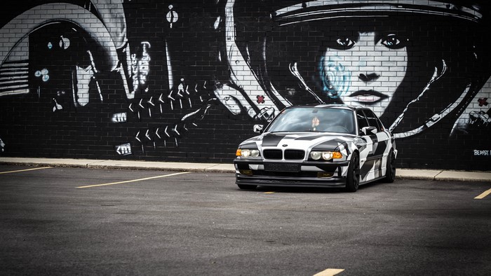 4K BMW with Camouflage Wrap in Front of Graffiti Wall