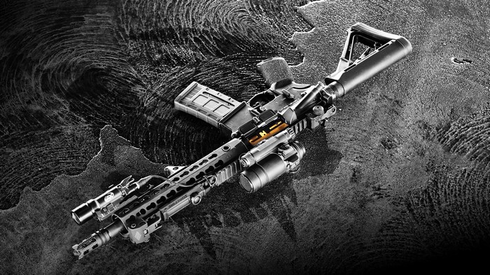 AR-15 rifle with accessories on textured surface