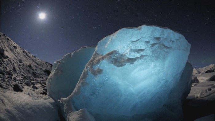 Glowing ice formations under a starry night sky