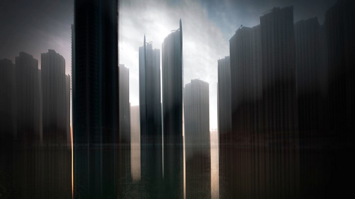 Abstract skyscrapers reflected in water