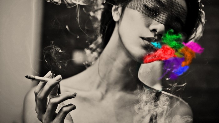 Woman smoking with colorful smoke