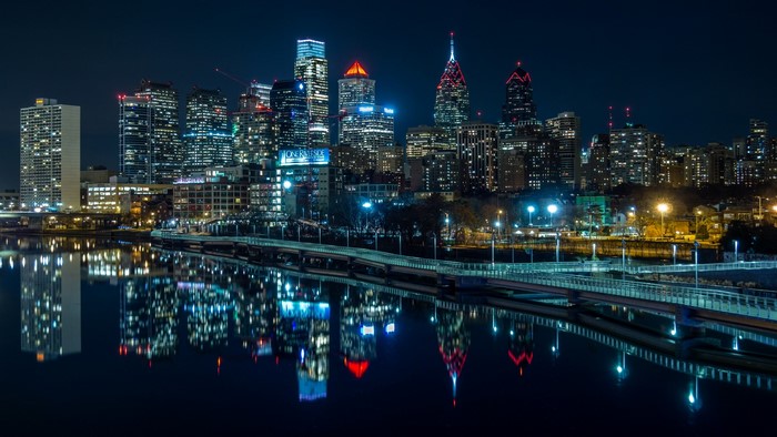 Philadelphia skyline at night with river reflections