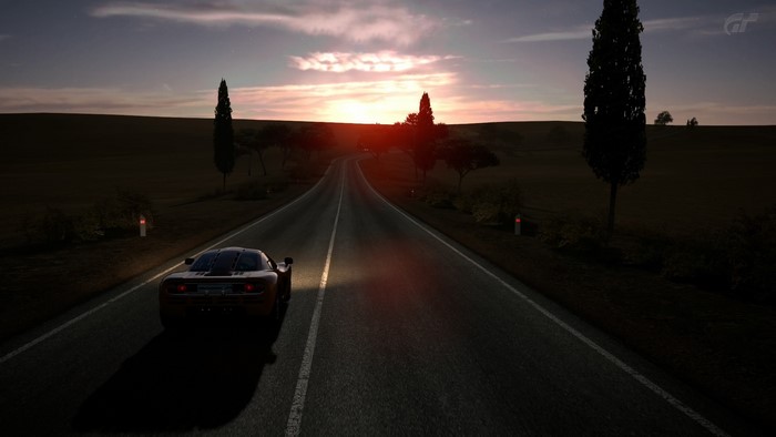 McLaren F1 on a road at sunset