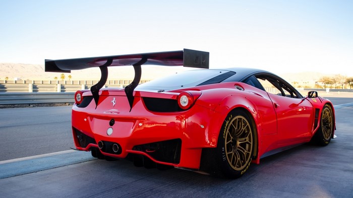 Red Ferrari 458 GT3 racing car with large rear wing