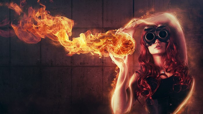 Woman with goggles conjuring fire