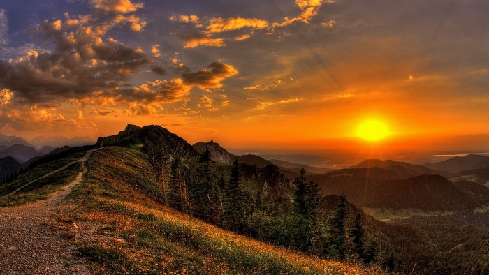 Sunset over mountains with a path