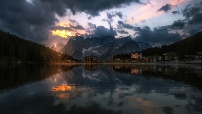 Lake with Mountains and Buildings at Sunset