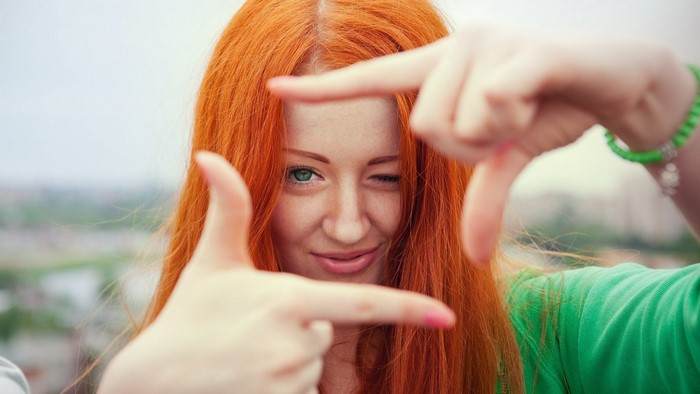 Woman with red hair framing her face