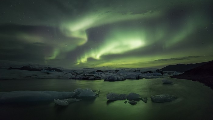 Aurora Borealis over Icebergs in Water
