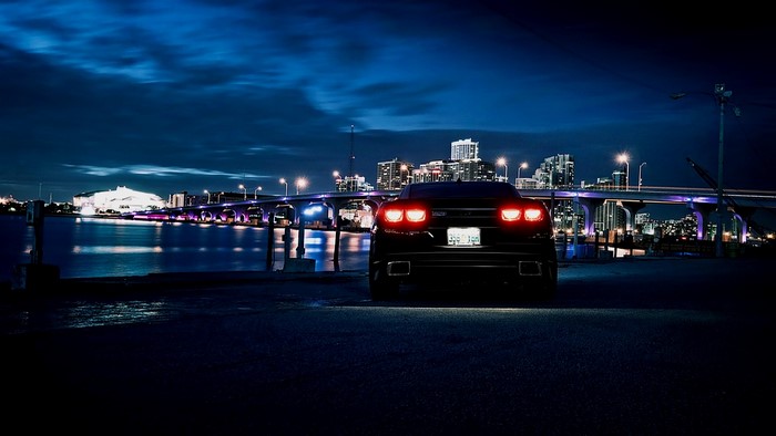 Black Chevrolet Camaro SS at Night with City Bridge