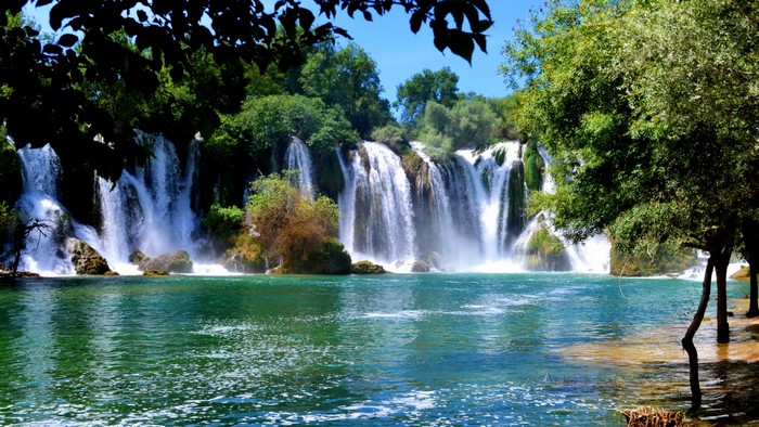 Waterfalls in a lush green landscape