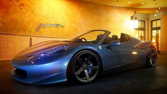 Blue Ferrari convertible parked indoors