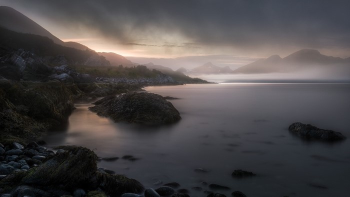 Misty Shoreline with Mountains at Sunrise