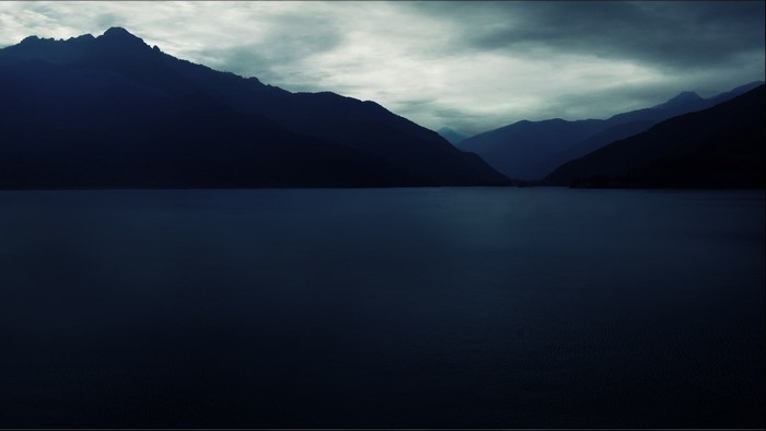 Dark Mountains Overlooking a Calm Lake