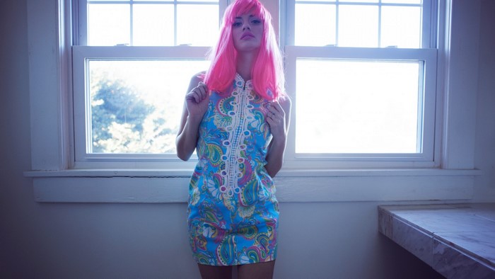 Woman with pink hair in a colorful dress