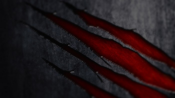 Red Claw Marks on Dark Surface