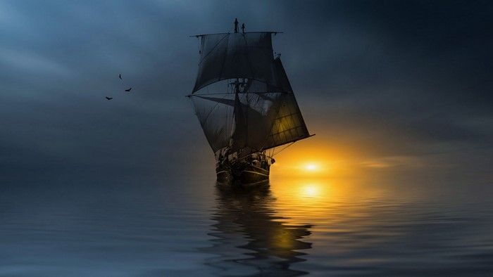 Sailboat on the ocean at sunset