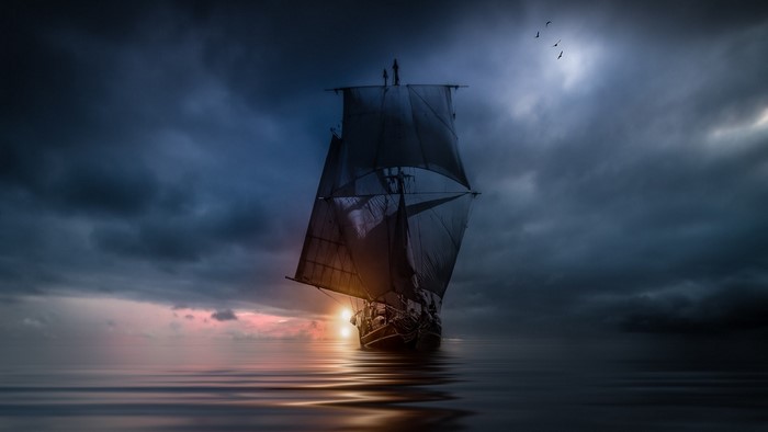 Sailboat on the ocean at sunset