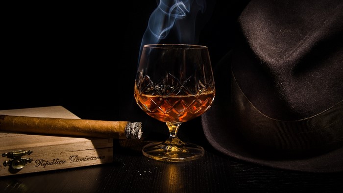 Cognac, cigar, and fedora hat