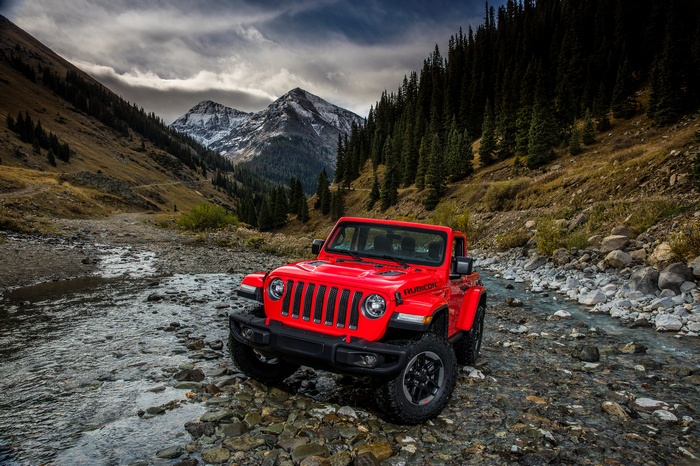 Red Jeep Wrangler Rubicon in a Mountainous Riverbed