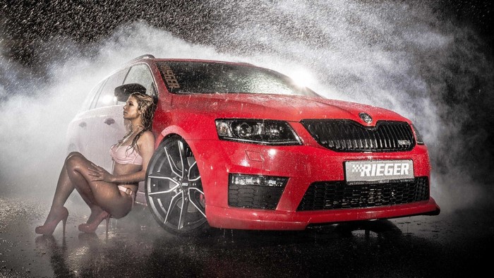 Woman in bikini and red Skoda car in rain