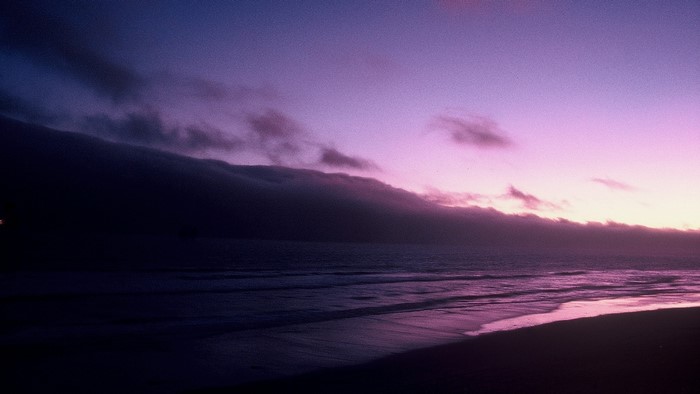 Purple sunset over the ocean and beach