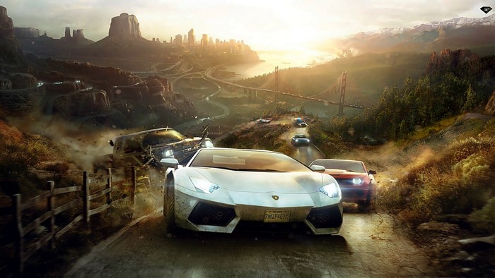 Cars racing on a mountain road with a city in the background