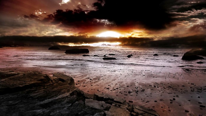 Dramatic sunset over a rocky beach