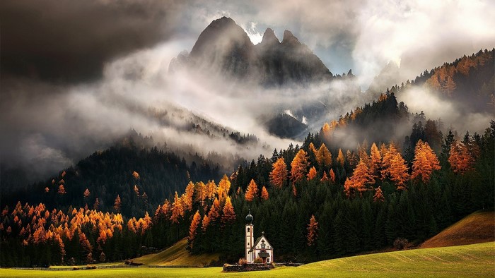 Chapel in the mountains with autumn trees