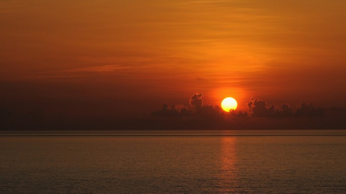 Sunset over the ocean with clouds