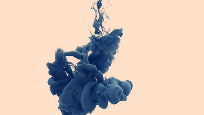 Dark blue ink dissolving in water