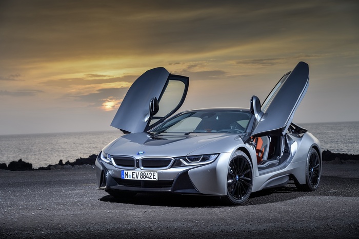 BMW i8 Coupe with doors open at sunset
