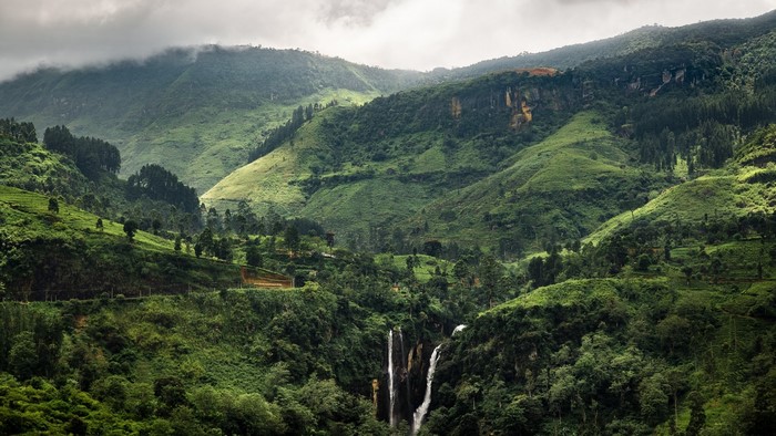 Waterfalls in a lush green mountain landscape