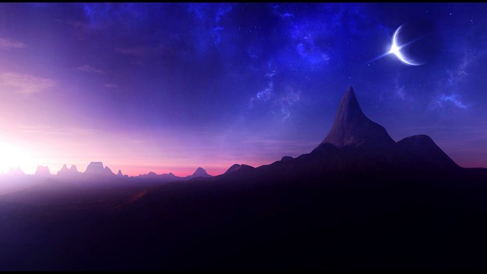 Crescent moon over mountains at twilight
