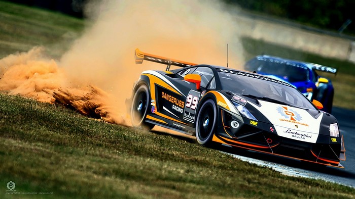 Lamborghini race car kicking up dust on track