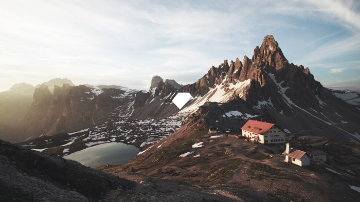 Mountain range with snow and a lake