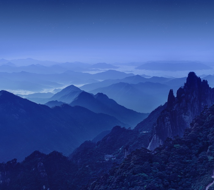 Mountain range at night with stars
