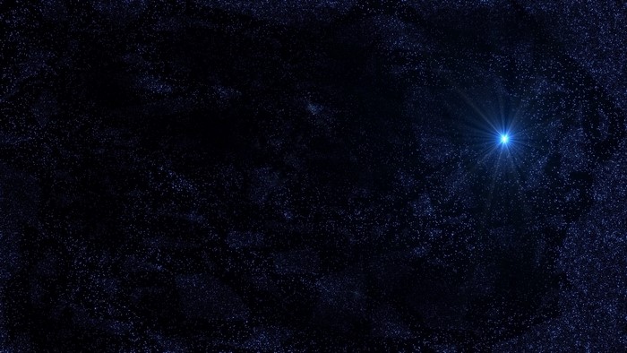 A bright blue star in the dark night sky