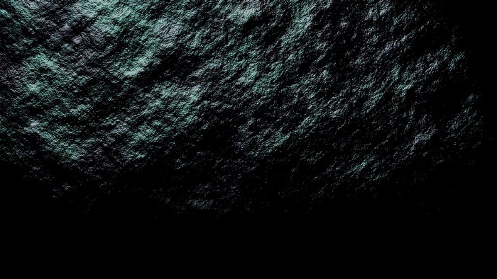 Textured rock surface with dark background
